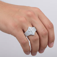 A hand adorned with the 0.97ct Moissanite Cross Religious Ring—its bold, silver cross design glittering with shimmering moissanite stones—is displayed against a plain light background.