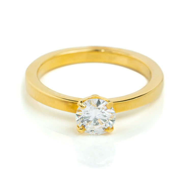 The 0.73ct Round Lab Diamond Solitaire Engagement Ring in 14k gold features a classic four-prong setting and clear lab diamond, shown against a white background.