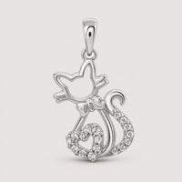 The 1/10 CTW Diamond Heart Cat Pendant in 10K Gold is perfect for cat lovers, featuring a gold cat outline with a heart-shaped, diamond-accented tail tip, shown on a plain warm off-white studio background.
