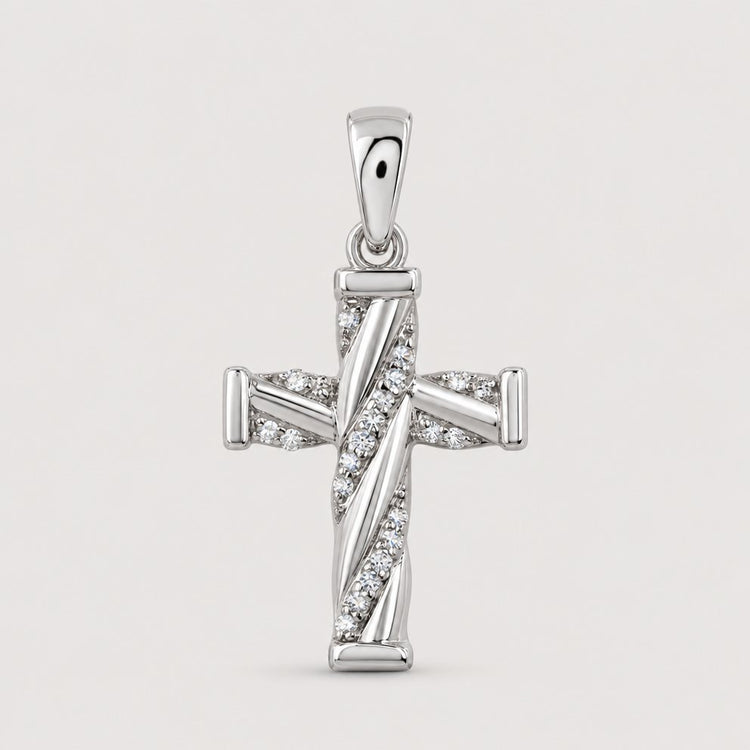 The 1/20 CTW Diamond Cross Pendant in 10K Gold features sparkling diagonal rows of natural diamonds, standing out beautifully against a plain warm off-white studio background.