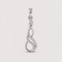 A 1/20 CTW Diamond Infinity Pendant in 10k Gold features two intertwined loops—one accented with sparkling diamonds—creating an elegant and modern design against a plain warm off-white studio background.