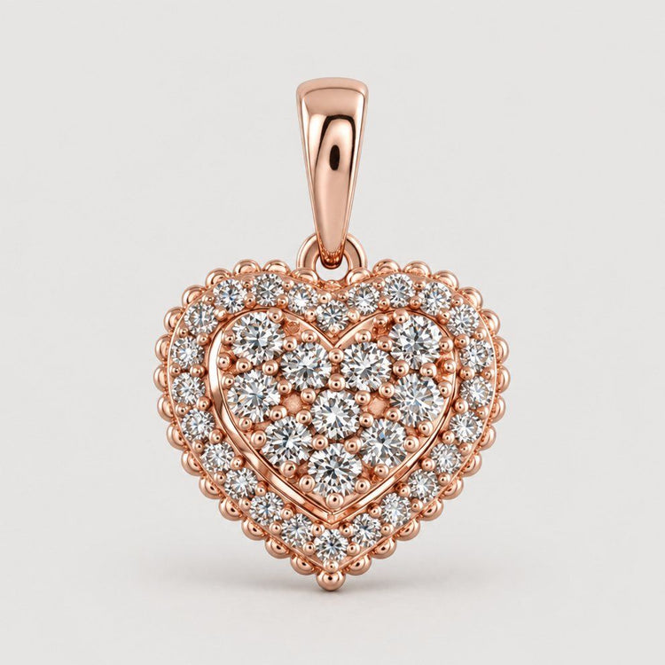 The 1/2 CTW Diamond Heart Pendant in 14K Gold showcases a double halo of round diamonds and a smooth bail, making it easy to wear and a timelessly elegant choice for any necklace.