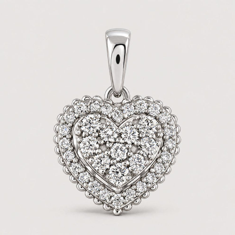 The 1/2 CTW Diamond Heart Pendant in 14K Gold features a heart-shaped design encrusted with sparkling diamonds, scalloped edges, and a polished bail, shown against a plain warm off-white studio background.