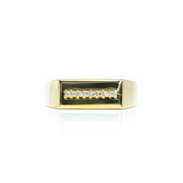 The Signet with Line of Gemstones Ring - 10k Gold is a men's signet ring with a rectangular setting featuring a row of seven small round diamonds at the center, shown against a white background.