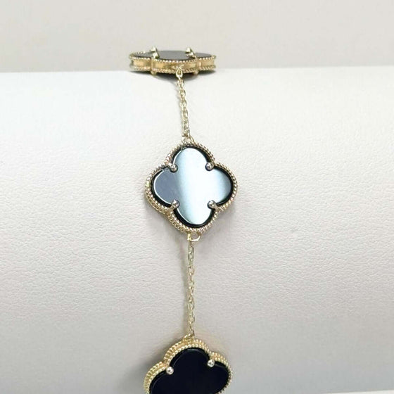 Onyx Four Leaf Clover Bracelet - 14k Yellow Gold 14k yellow gold bracelet featuring sleek black onyx four leaf clovers. A modern and elegant symbol of good luck. Shop the Onyx Clover Bracelet today!