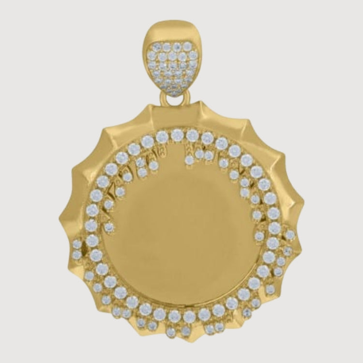The 10k Gold Picture Pendant with CZ Stone Cluster features a round shape, jagged sunburst edge, and a smooth center for custom photos. Its border and bail are accented with sparkling CZ stones for added brilliance.