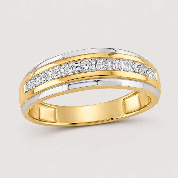 The 10k Two-Tone Gold Diamond Wedding Band – 1/4 Cttw features a row of round diamonds in a central channel and sleek white gold edges, displayed on a warm off-white studio background.