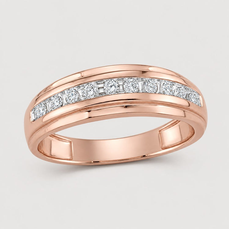A 10k two-tone gold diamond wedding band – 1/4 cttw, featuring a row of round white diamonds set in a channel across the top, displayed on a plain warm off-white studio background.