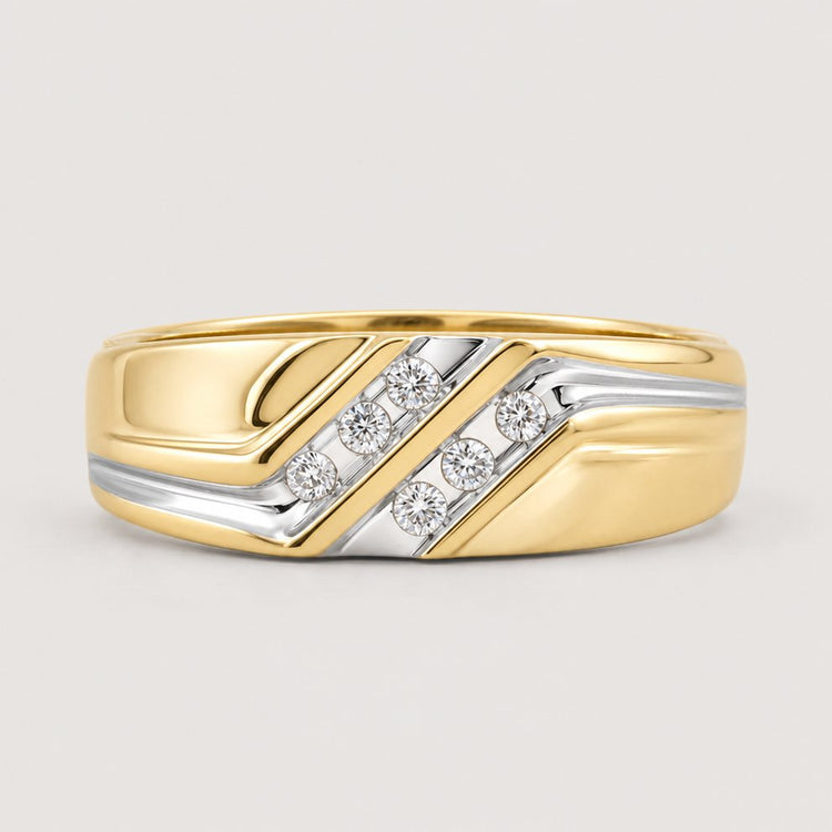 The 10k Two-Tone Gold Diamond Wedding Band – 1/8 Cttw features a polished finish, diagonal silver accents, and five small round diamonds set in a row within the silver section, displayed on a warm off-white studio background.