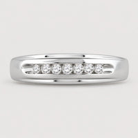 The 10k White Gold Round Diamond Wedding Band 1/4 Cttw features a row of seven round diamonds set horizontally in a channel across the center, shown on a warm off-white studio background.