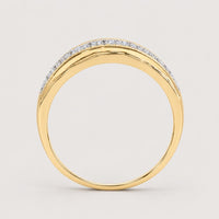 A side view of the 10K Yellow Gold Diamond Band Ring 1/3 Cttw showcases its slim yellow gold band with a row of sparkling diamonds along the top edge, all set against a plain warm off-white studio background.