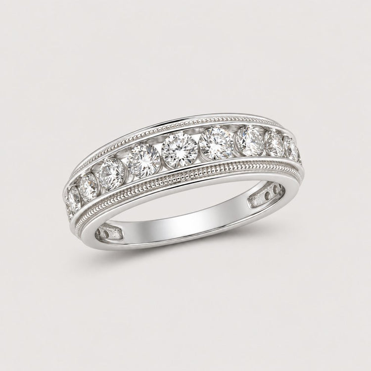 A 10k gold round diamond band ring with a row of sparkling diamonds, totaling 2 CTTW, each set in a bezel setting and displayed on a warm off-white studio background.
