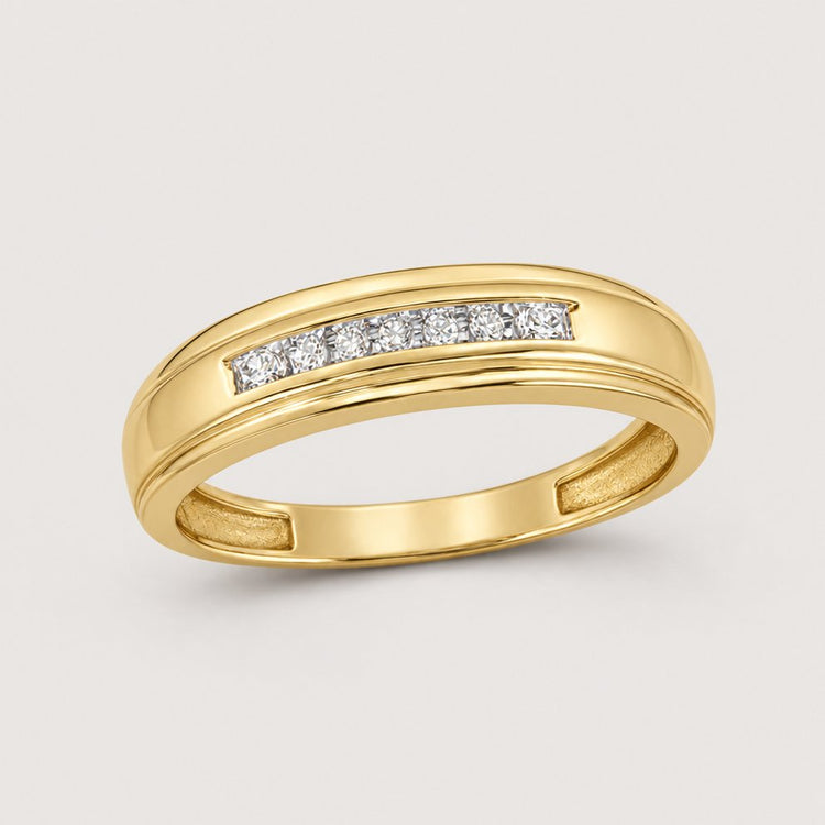 The 10k Gold Round Diamond Wedding Band – 1/12 Cttw features a row of channel-set diamonds across the top, shown against a warm off-white studio background.