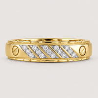 The 10K Yellow Gold 1/5 CTW Diamond Wedding Band features diagonal rows of small round diamonds set in the center with two screw-like accents on each side, shown against a warm off-white studio background.