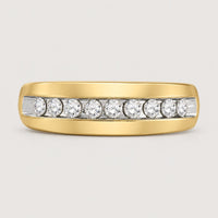 The 10k Gold Round Diamond Wedding Band 1/2 Cttw features seven round diamonds in a horizontal channel setting, displayed on a warm off-white studio background.