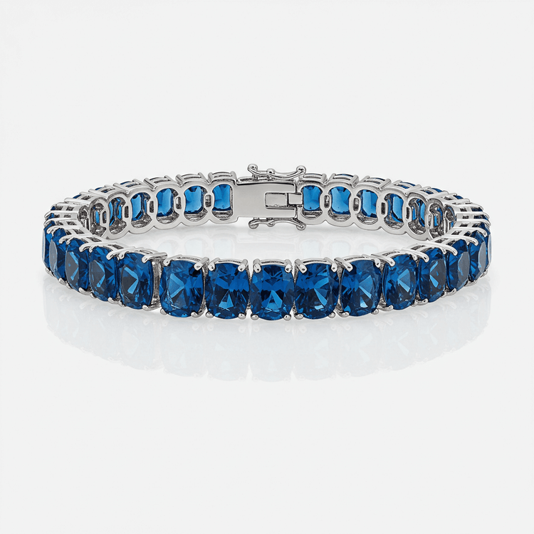 Blue Moissanite Tennis Bracelet-10mm: This 925 sterling silver bracelet features large cushion-cut deep blue moissanite gemstones in prong settings, forming a continuous circle, shown against a white background.