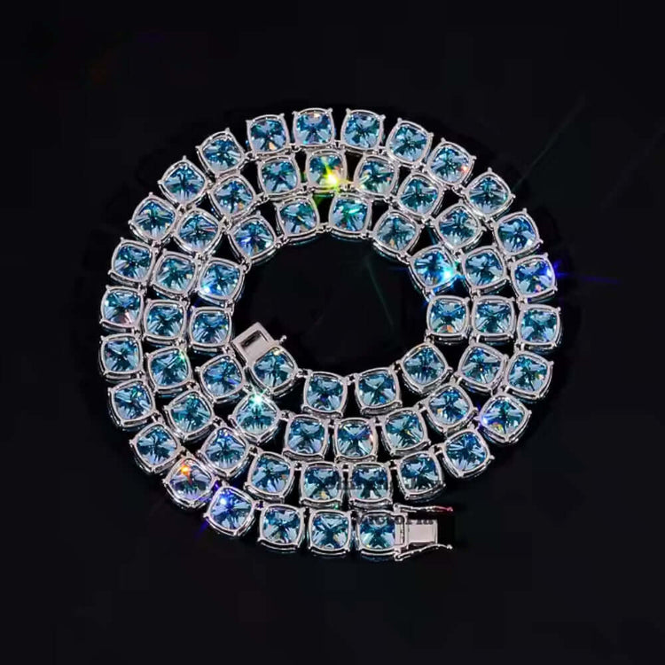 The Blue Moissanite Tennis Chain - 10mm shines with square blue moissanite gems, double-looped in a spiral on a black background, each stone reflecting light with captivating brilliance.