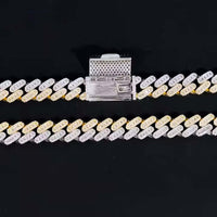 The Moissanite Cuban Link Chain - 10mm features a bold design with alternating gold and 925 sterling silver links and a large rectangular clasp, shown against a solid black background for a contemporary look.