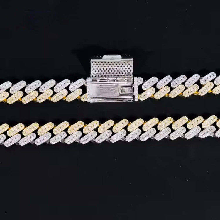 The Moissanite Cuban Link Chain - 10mm features a bold design with alternating gold and 925 sterling silver links and a large rectangular clasp, shown against a solid black background for a contemporary look.