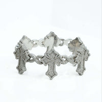 The Diamond Cross Bracelet - 10k Gold showcases large cross-shaped links encrusted with sparkling stones, elegantly displayed against a white background.