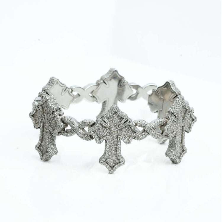 The Diamond Cross Bracelet - 10k Gold showcases large cross-shaped links encrusted with sparkling stones, elegantly displayed against a white background.