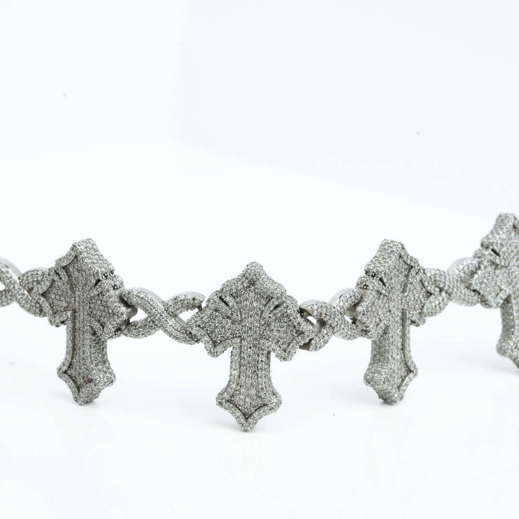A close-up of the Diamond Cross Bracelet in 10k gold showcases large, diamond-encrusted cross pendants linked on a silver-toned chain against a white background.