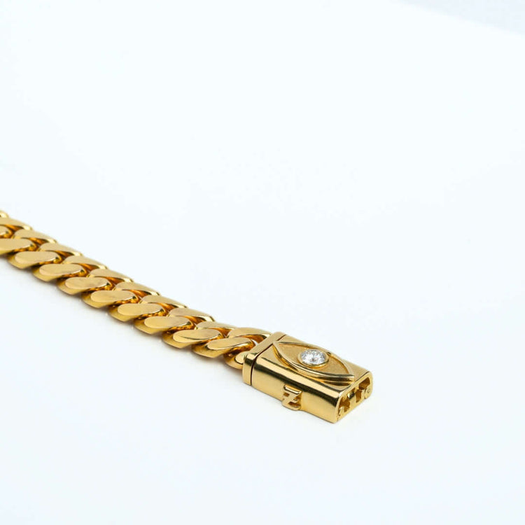 A close-up of the 12mm Handmade Miami Cuban Link Chain with Evil Eye Lock, crafted in 14K solid gold, displayed on a plain white background.