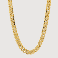 A close-up of the Cuban Link Chain Evil Eye Lock 14k Gold - 12mm, shown on a plain white background. This necklace features thick, flat, interlocking polished links in shiny 14k gold.