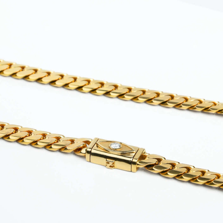 A close-up of the 12mm Handmade Miami Cuban Link Chain with Evil Eye Lock in 14K solid gold, featuring a flat rectangular clasp and displayed on a white background.