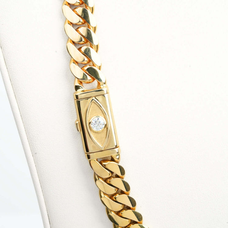 A close-up of a 12mm Handmade Miami Cuban Link Chain with Evil Eye Lock in 14K solid gold, displayed against a white background.