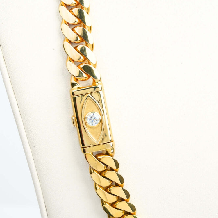 A close-up of the 12mm Handmade Miami Cuban Link Chain with Evil Eye Lock, crafted in 14K solid gold, shown on a white background.