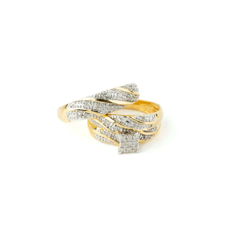 The 1/3 CTW 10k Yellow Gold Wedding Trio Set features overlapping gold bands accented with sparkling diamonds and a bold square diamond cluster centerpiece—ideal as an engagement ring or for a wedding trio.