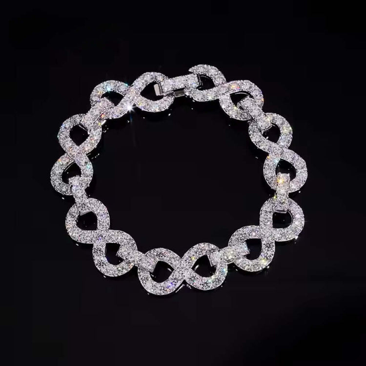 The Silver Moissanite Infinity Bracelet - 13mm features large interlocking links in a circular design, sparkling with diamond-like brilliance, elegantly displayed against a black background.