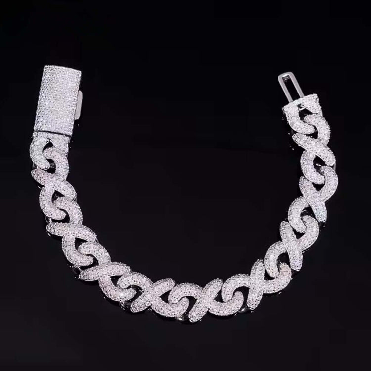 The Silver Moissanite Infinity Link Chain -13MM, a diamond-encrusted Cuban link bracelet with a large rectangular clasp, is showcased against a black background—an exquisite piece of moissanite jewelry.
