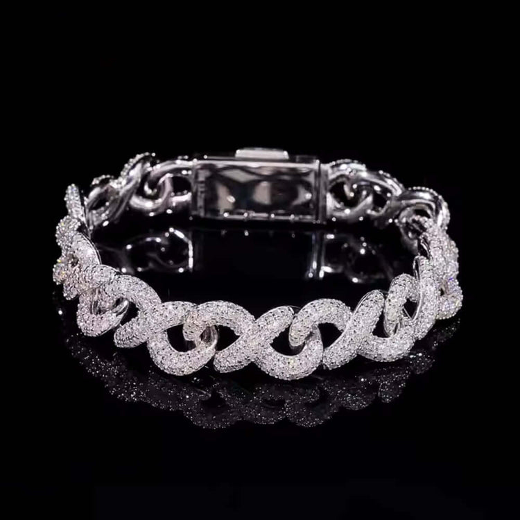 The Silver Moissanite Infinity Link Chain -13MM is showcased in a circular shape on a reflective black surface, highlighting its sparkling moissanite links.