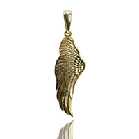 The 14K Gold Angel Wing Pendant, with intricate feather engravings and a polished finish, stands upright against a white background.