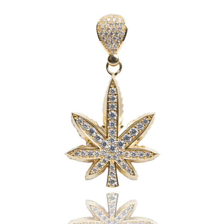 The Cannabis Pendant with CZ Stones - 14k Gold features a leaf-shaped design encrusted with sparkling stones, shown on a white background—a striking piece of cannabis-inspired jewelry.