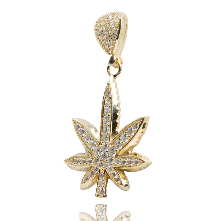 The Cannabis Pendant with CZ Stones - 14k Gold features a cannabis leaf shape, sparkling CZ stones on the leaf and bail, and is shown against a white background—a striking piece of cannabis jewelry.