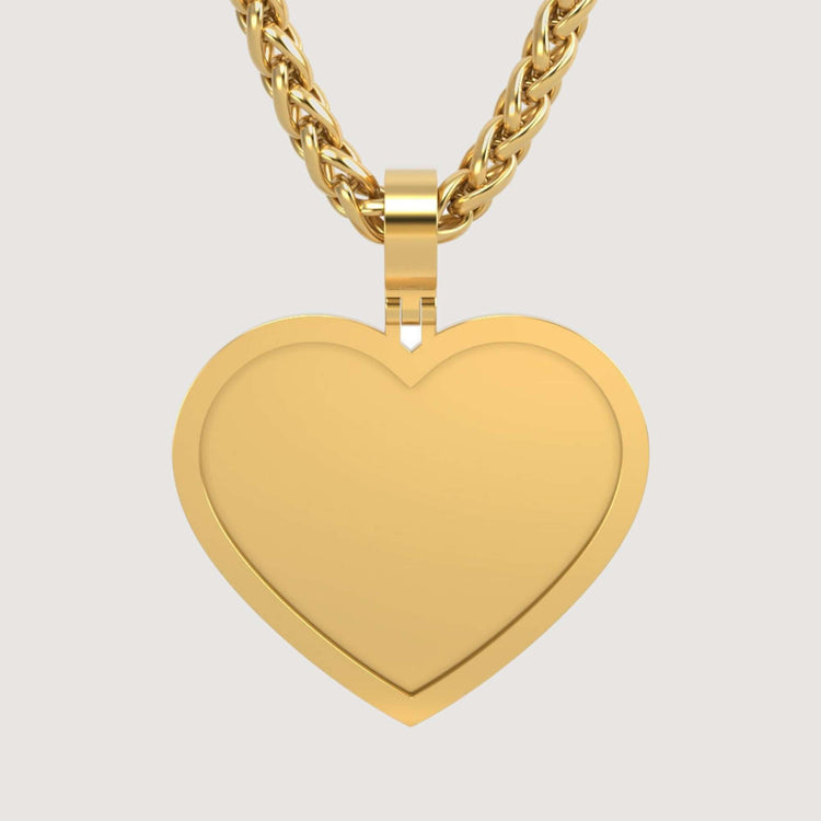 The 14K Gold Classic Heart Picture Pendant hangs from a thick, twisted gold chain against a plain light background, creating an elegant personalized keepsake.