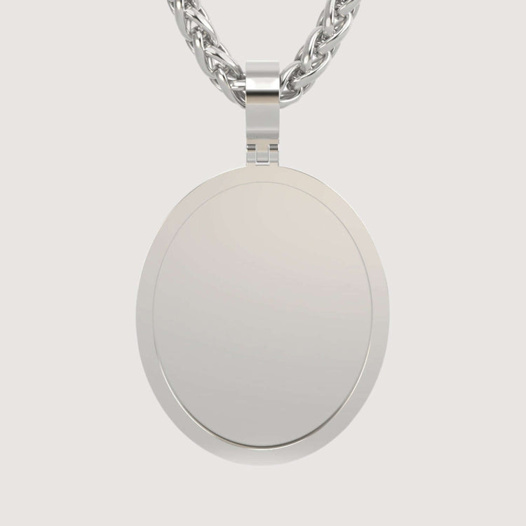 A close-up of the 14K Gold Classic Oval Picture Pendant on a thick, braided chain against a light background. The polished, closed locket's smooth surface exudes timeless elegance.