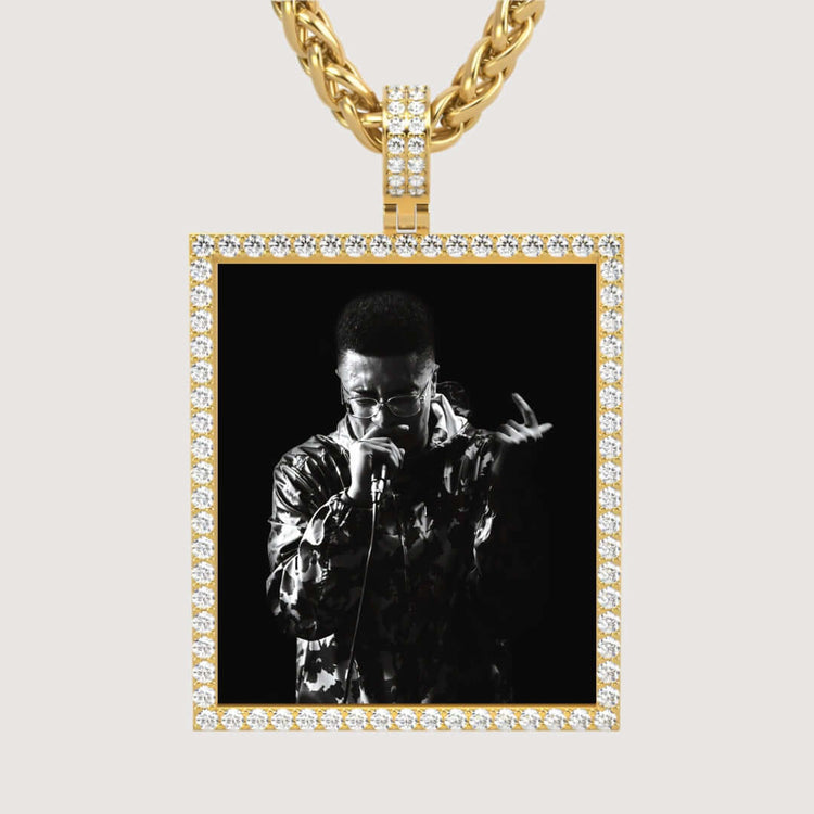 The 14k Gold Customizable Picture Pendant with Diamonds is a chain necklace featuring a diamond-accented pendant that can display your chosen black-and-white photo, such as someone singing into a microphone.