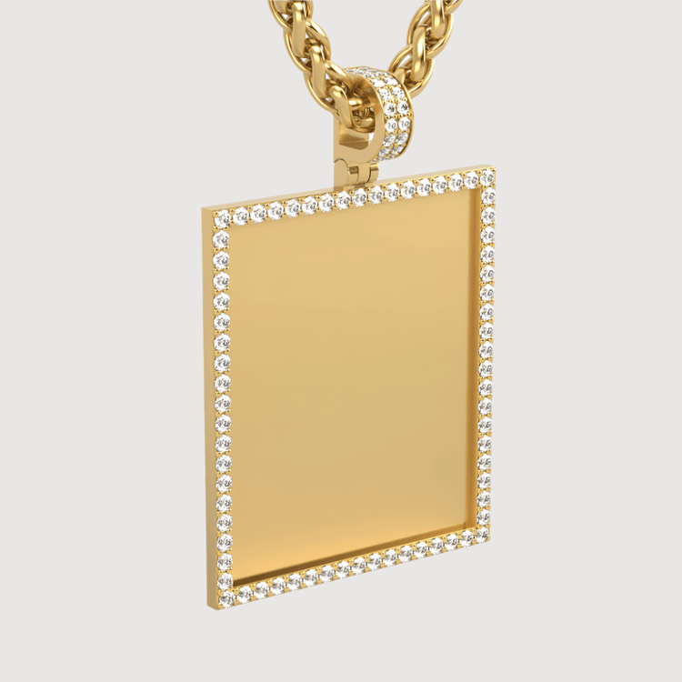 The 14k Gold Customizable Picture Pendant with Diamonds features a rectangular gold pendant bordered with diamonds and a diamond-studded bail, hanging from a twisted gold chain against a plain white background.