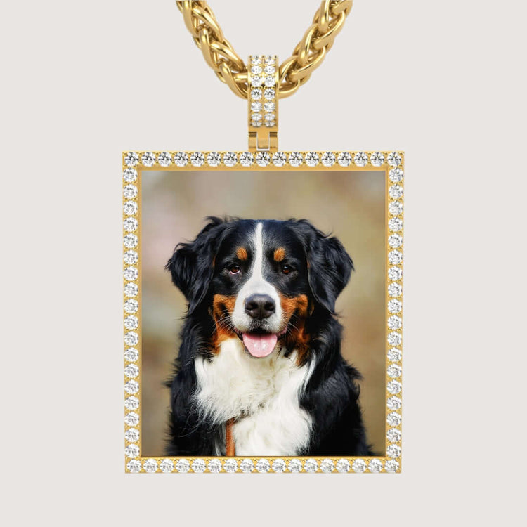 The 14k Gold Customizable Picture Pendant with Diamonds displays a rectangular, diamond-studded frame and features a personalized image of a happy Bernese Mountain Dog with a black, white, and brown coat sitting and facing the camera.