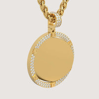 The 14K Gold Diamond-Accented Round Picture Pendant features a smooth gold center framed by two rows of sparkling diamonds on the edge and bail, elegantly hanging from a thick twisted gold chain.