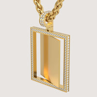 The 14K Gold Diamond Frame Rotating Photo Pendant features a rectangular 14K gold chain necklace with a clear center framed by two rows of sparkling diamonds. The pendant is showcased on a plain, light background.