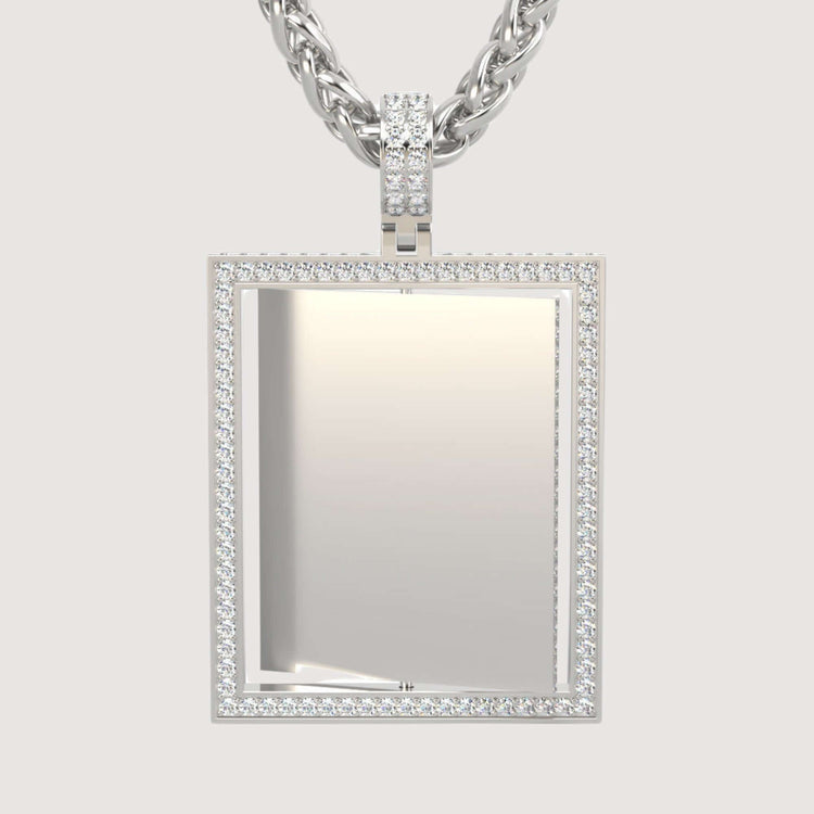 A 14K gold Diamond Frame Rotating Photo Pendant, featuring a sparkling diamond border and an open center for a photo, hangs from a gold chain against a plain light background.