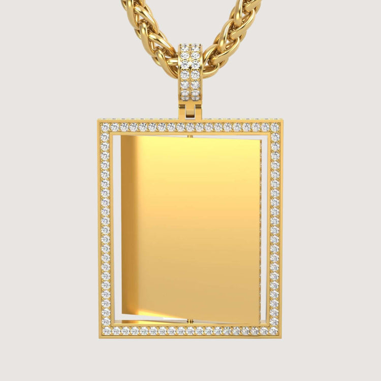 The 14K Gold Diamond Frame Rotating Photo Pendant features a rectangular gold frame outlined with small clear gemstones and hangs from a thick gold rope chain against a plain light background.