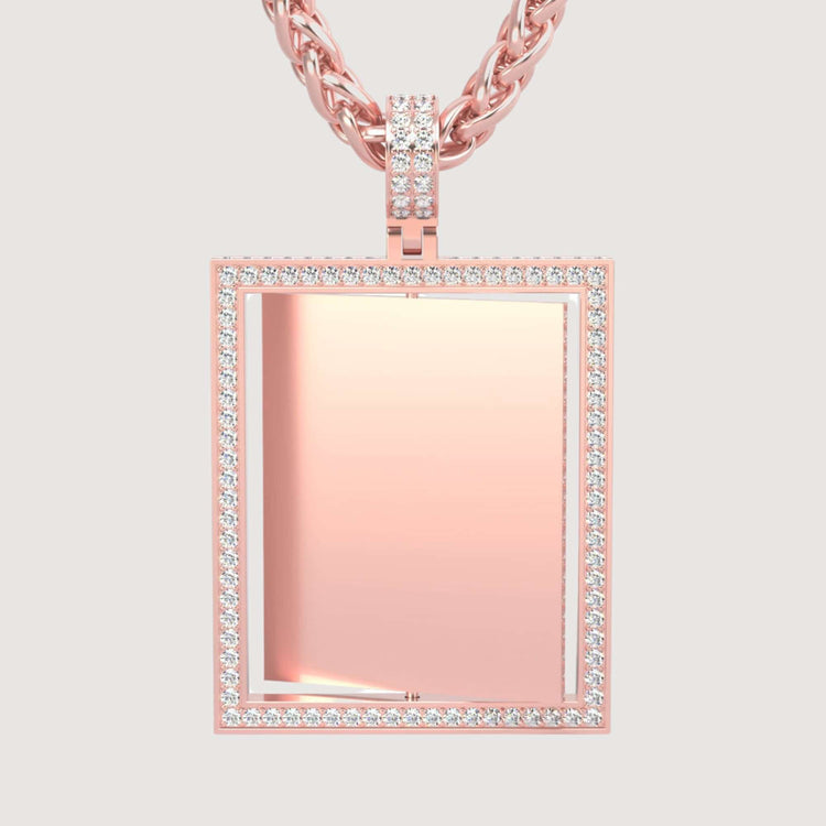 The 14K Gold Diamond Frame Rotating Photo Pendant features a rose gold rectangular design with a sparkling diamond border and plain center, suspended from a matching chain—an elegant touch for any occasion.