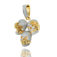 This 14k Hear No Evil, See No Evil, Speak No Evil Pendant features three diamond skulls with golden hands over their eyes, ears, and mouth—a unique take on the iconic wise monkeys symbol.