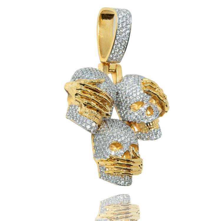 The 14k Hear No Evil, See No Evil, Speak No Evil Pendant features diamond-encrusted skulls with gold hands over their eyes, ears, and mouth—symbolizing the classic three wise monkeys.